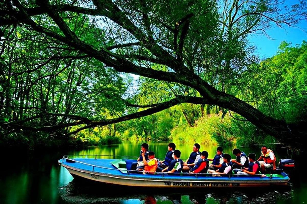 a group of people in a blue boat on a river