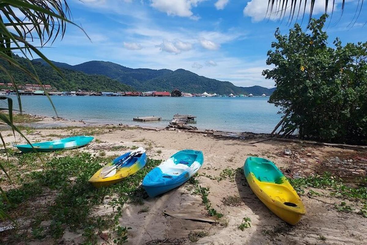 a group of three kayaks sitting on a beach