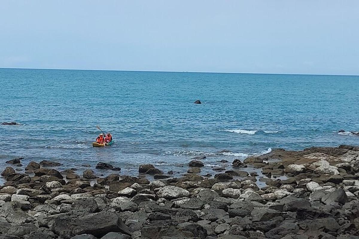 a group of people in a boat in the water