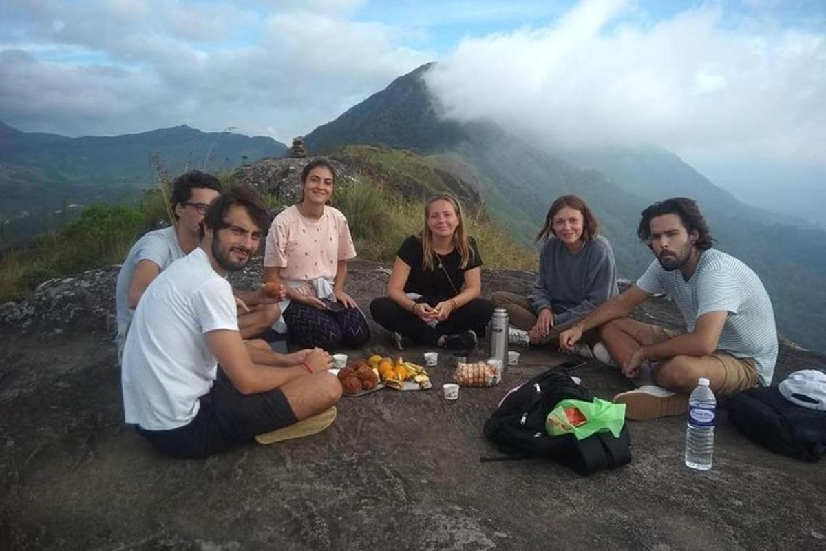 a group of people sitting on top of a mountain