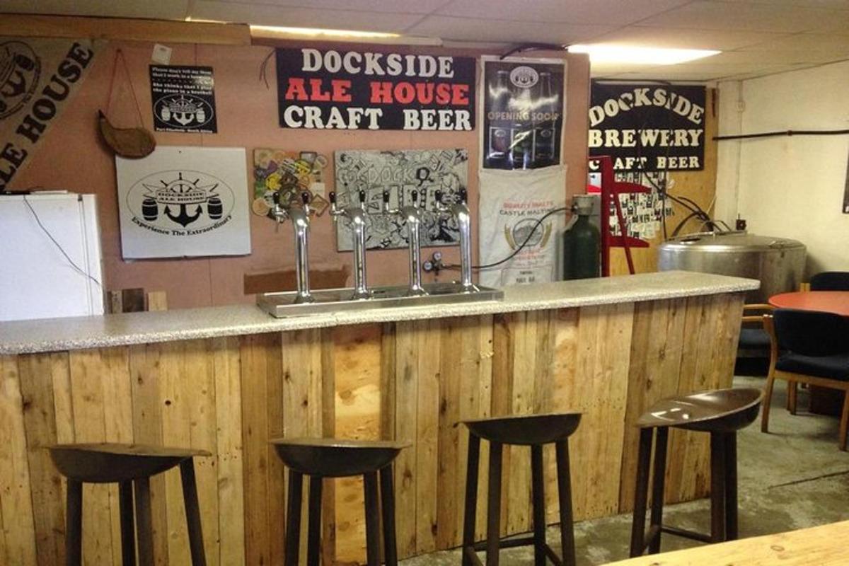 a bar with four stools at a counter in a restaurant