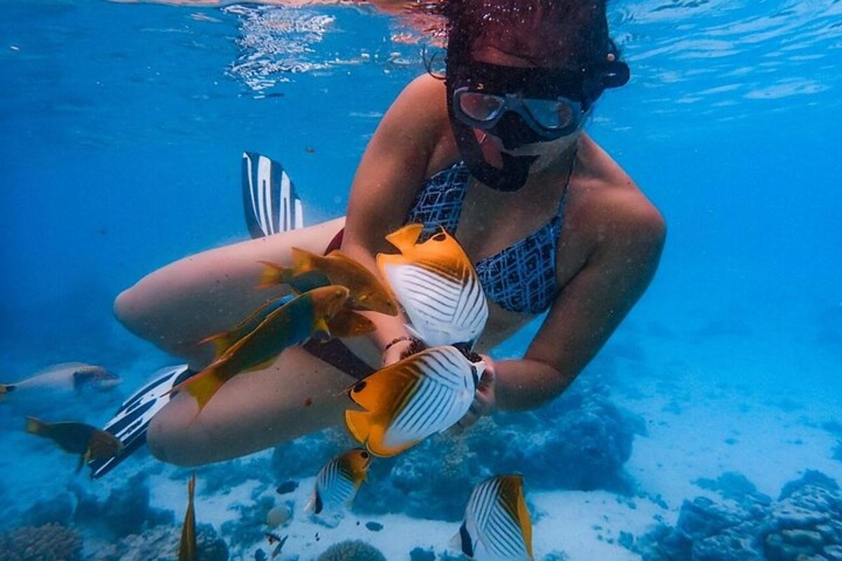 a woman in the water holding two fish