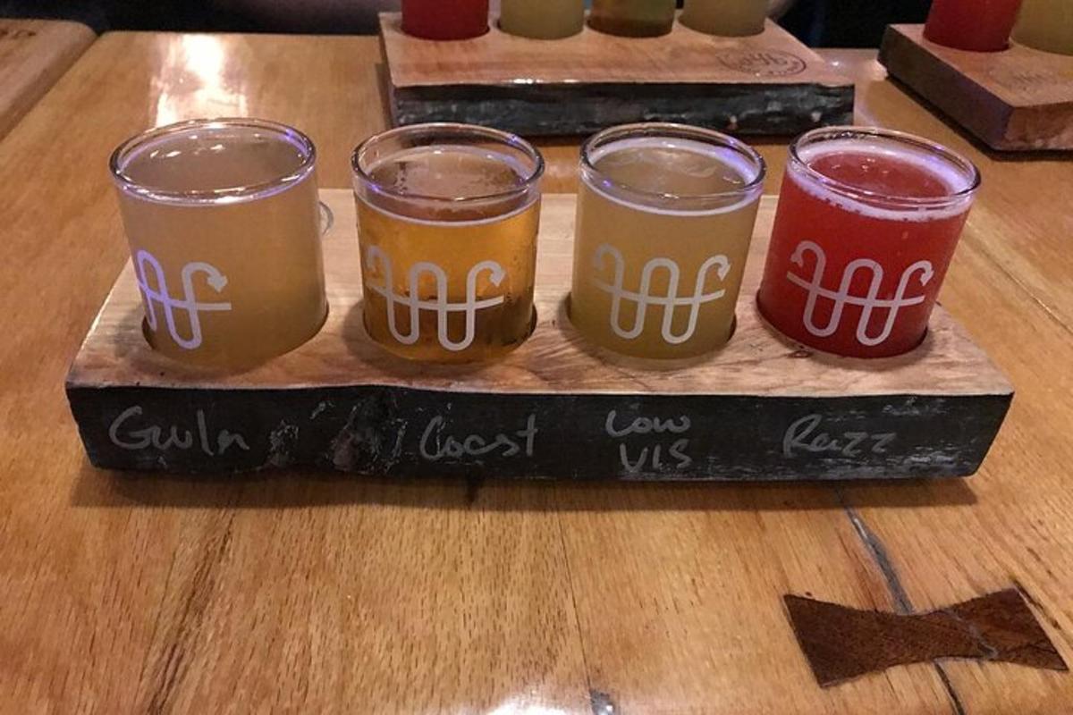 apat na baso ng beer na nakaupo sa kahoy na mesa