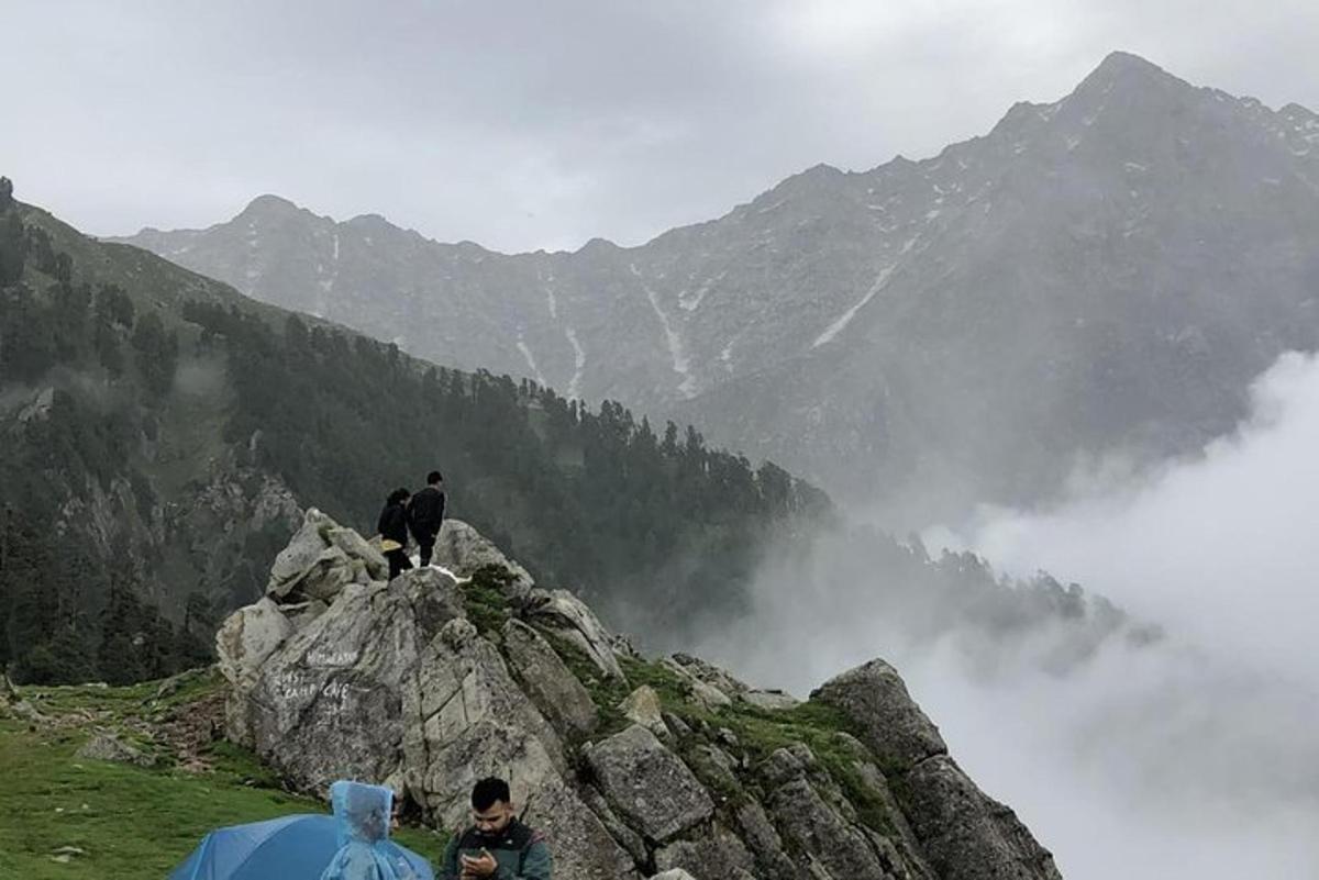 a group of people standing on top of a mountain