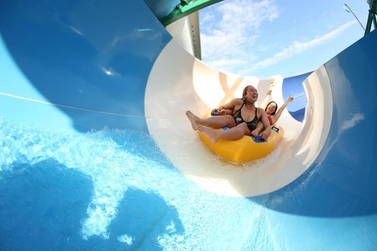 a couple of people riding a ride in a wave pool