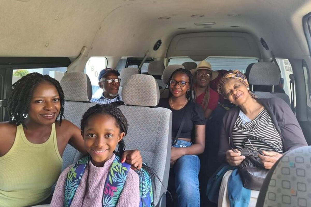 a group of people sitting in the back of a van