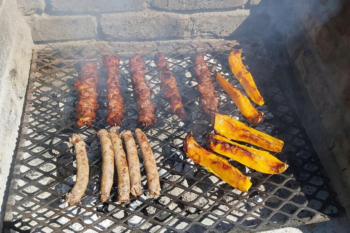 a bunch of sausages and other food on a grill