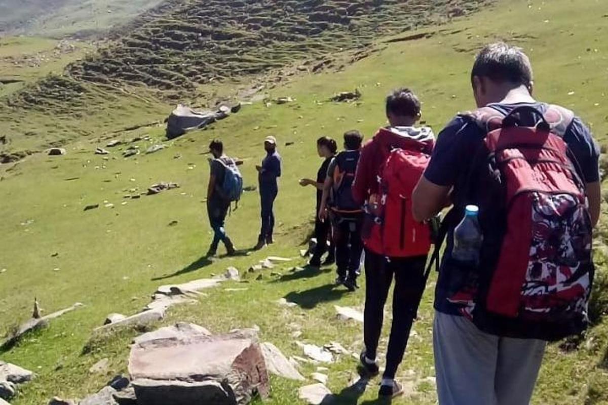 a group of people walking up a mountain