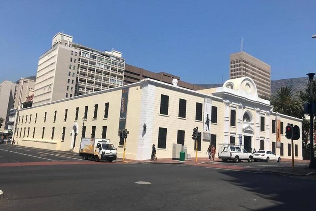 a large white building with cars parked in front of it