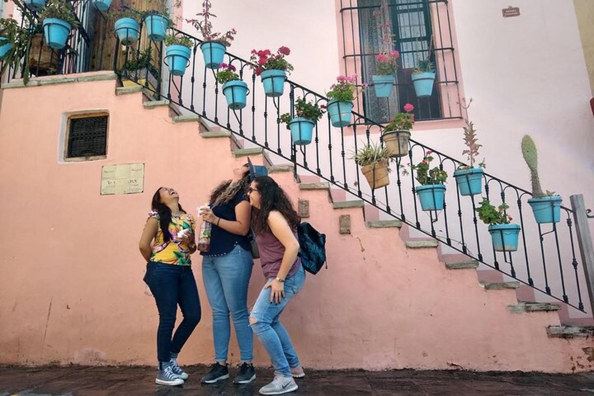 three girls are standing next to a staircase