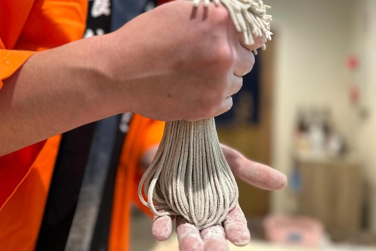 a person is holding a ball of gray yarn