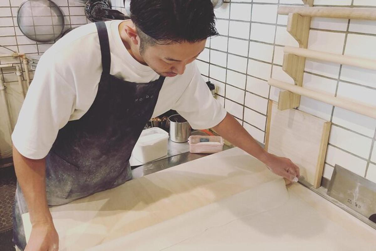a man in a kitchen preparing food on a counter