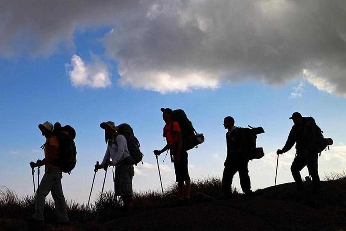 um grupo de pessoas caminhando no topo de uma colina