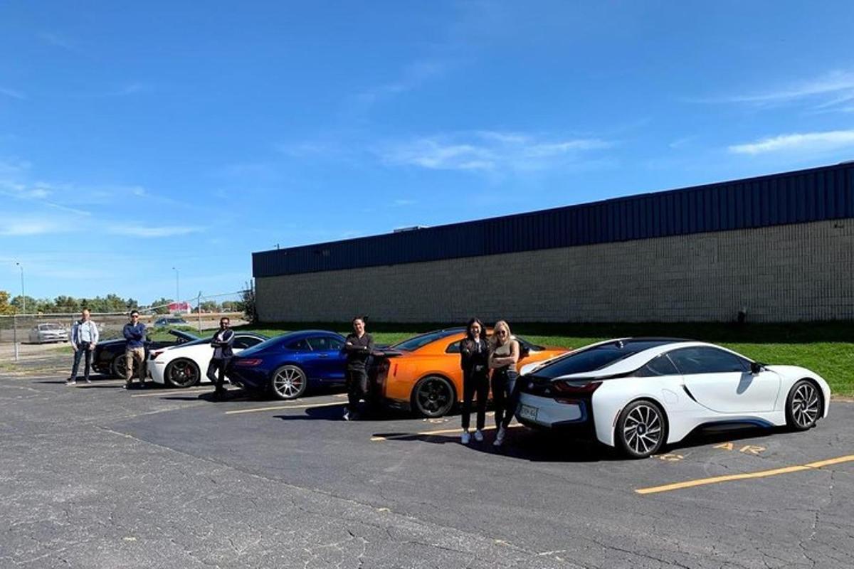 a group of people standing next to parked cars