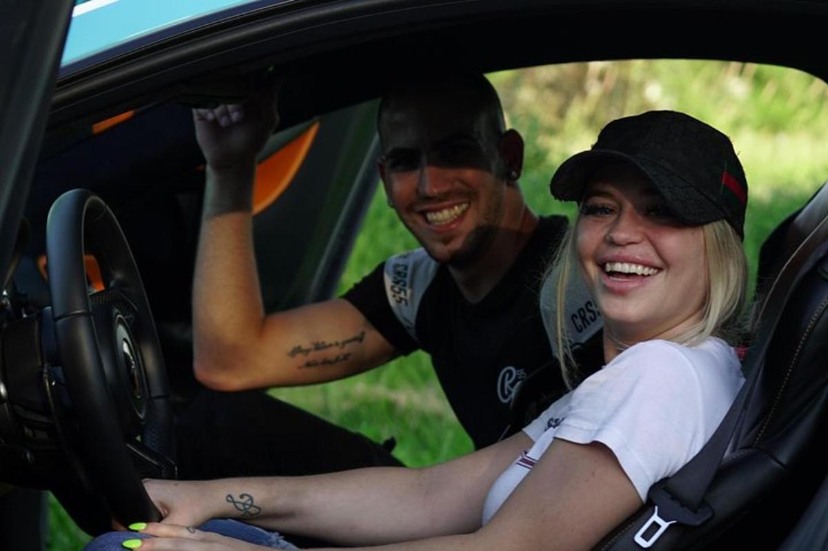 a man and a woman sitting in a car