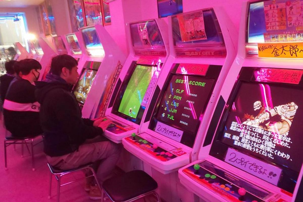 a group of people playing a video game in a arcade