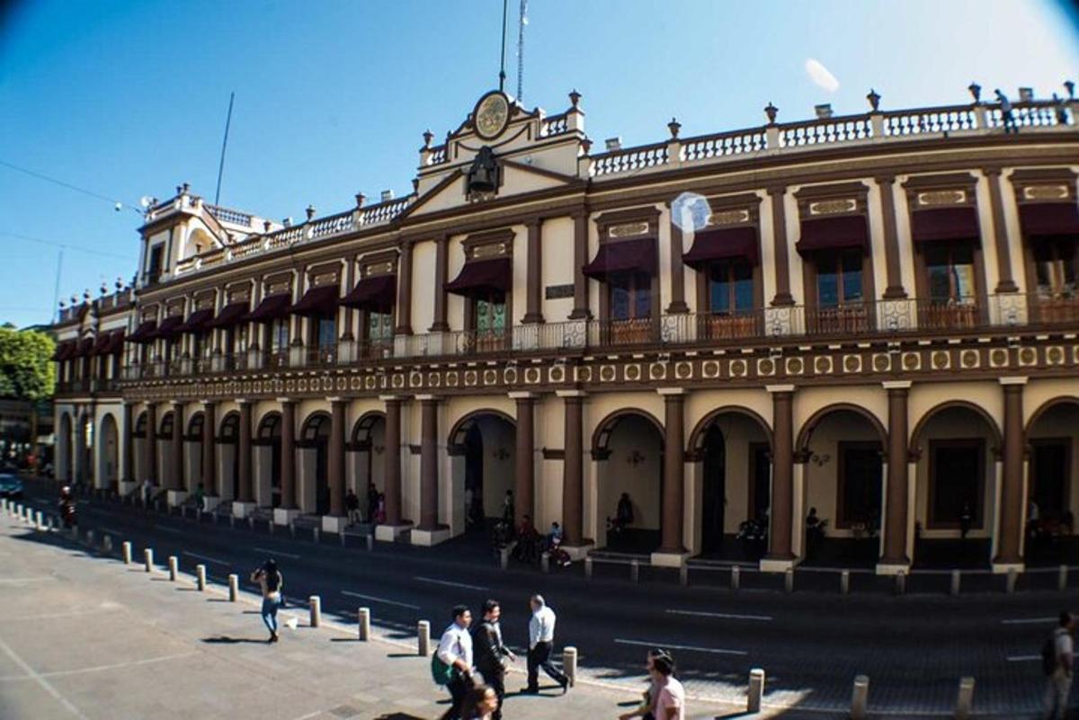 a large building with people walking in front of it