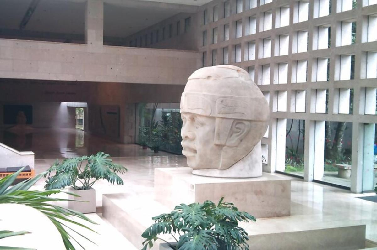 a large statue of a head in a building
