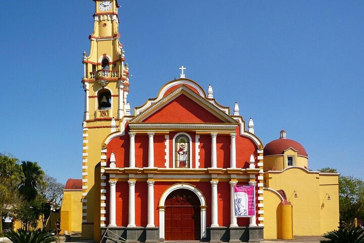 a red and yellow church with a clock tower