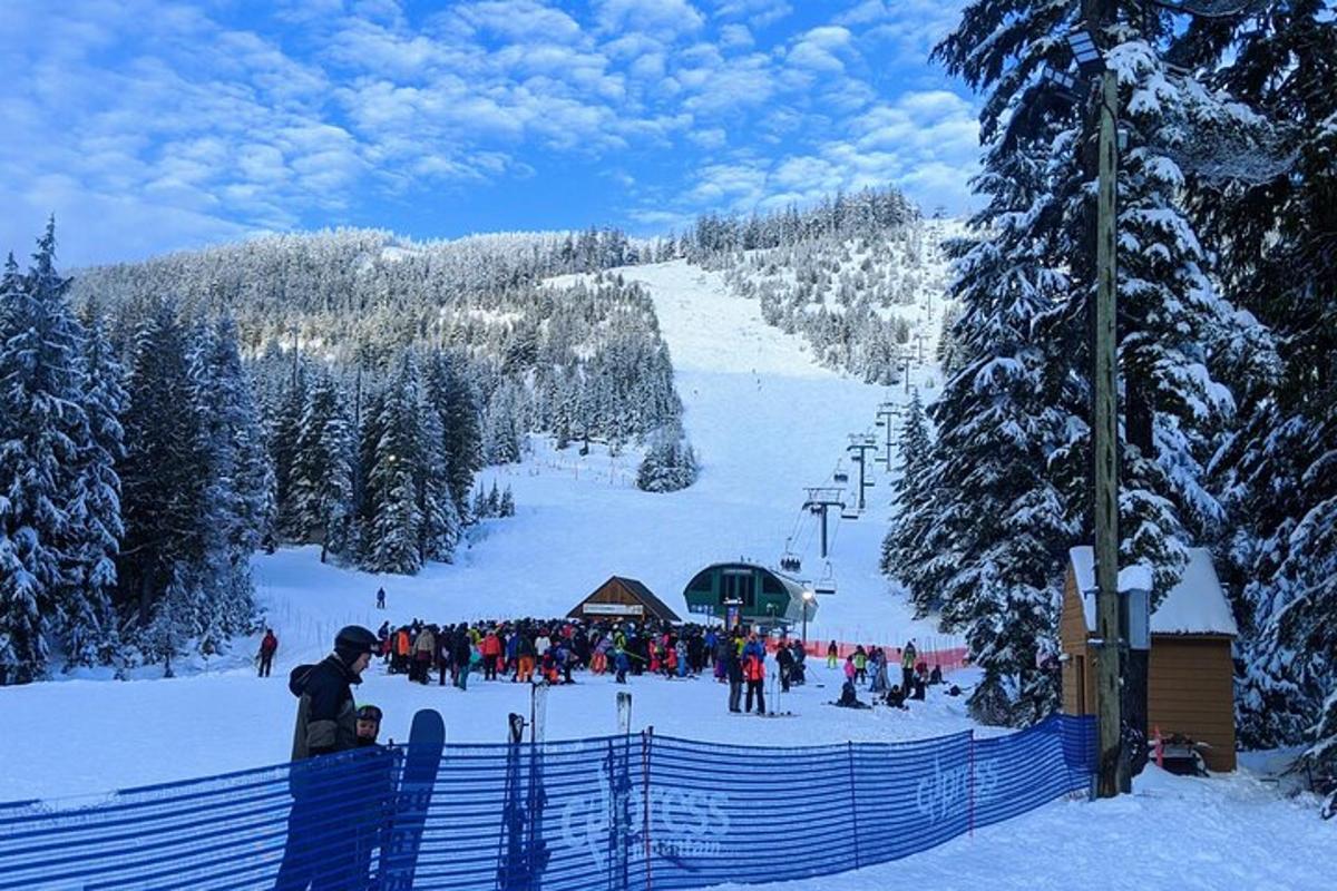 a group of people on a ski slope with a ski lift