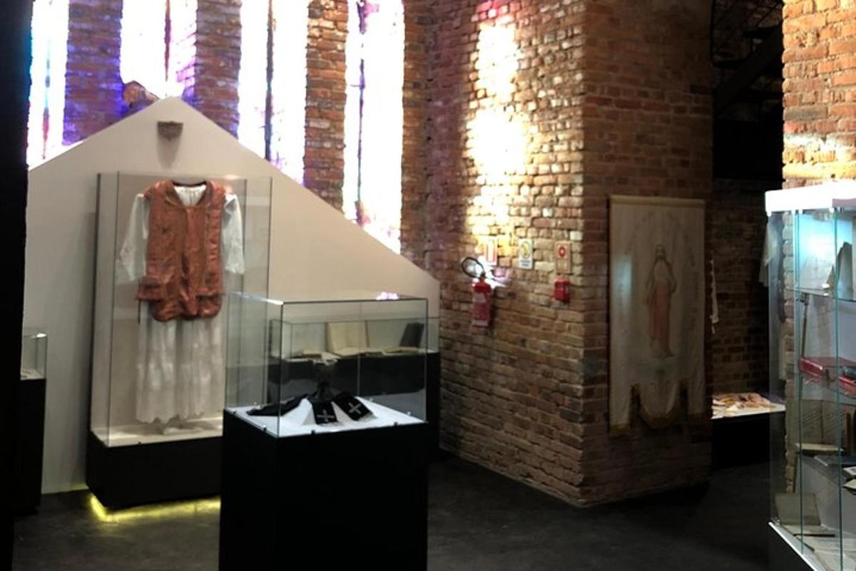 a display case with a dress in a brick wall