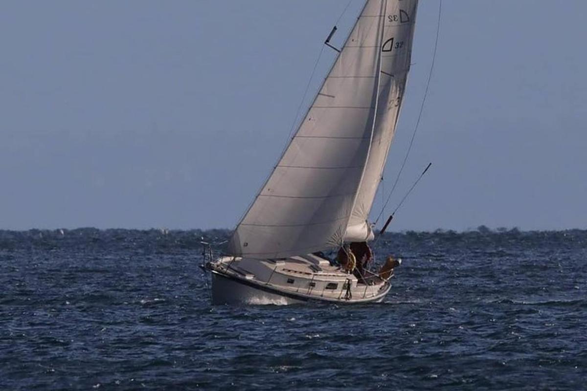 a sail boat in the ocean on the water