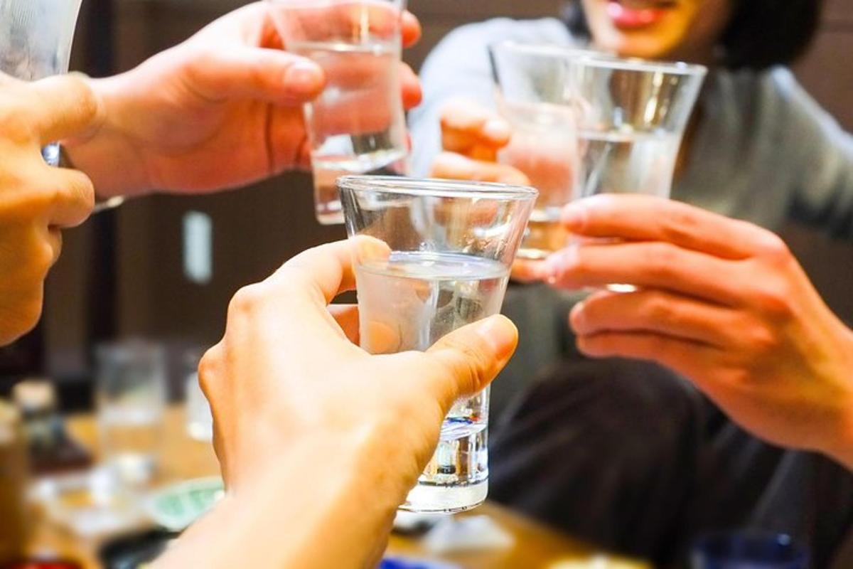 a group of people holding up glasses of water
