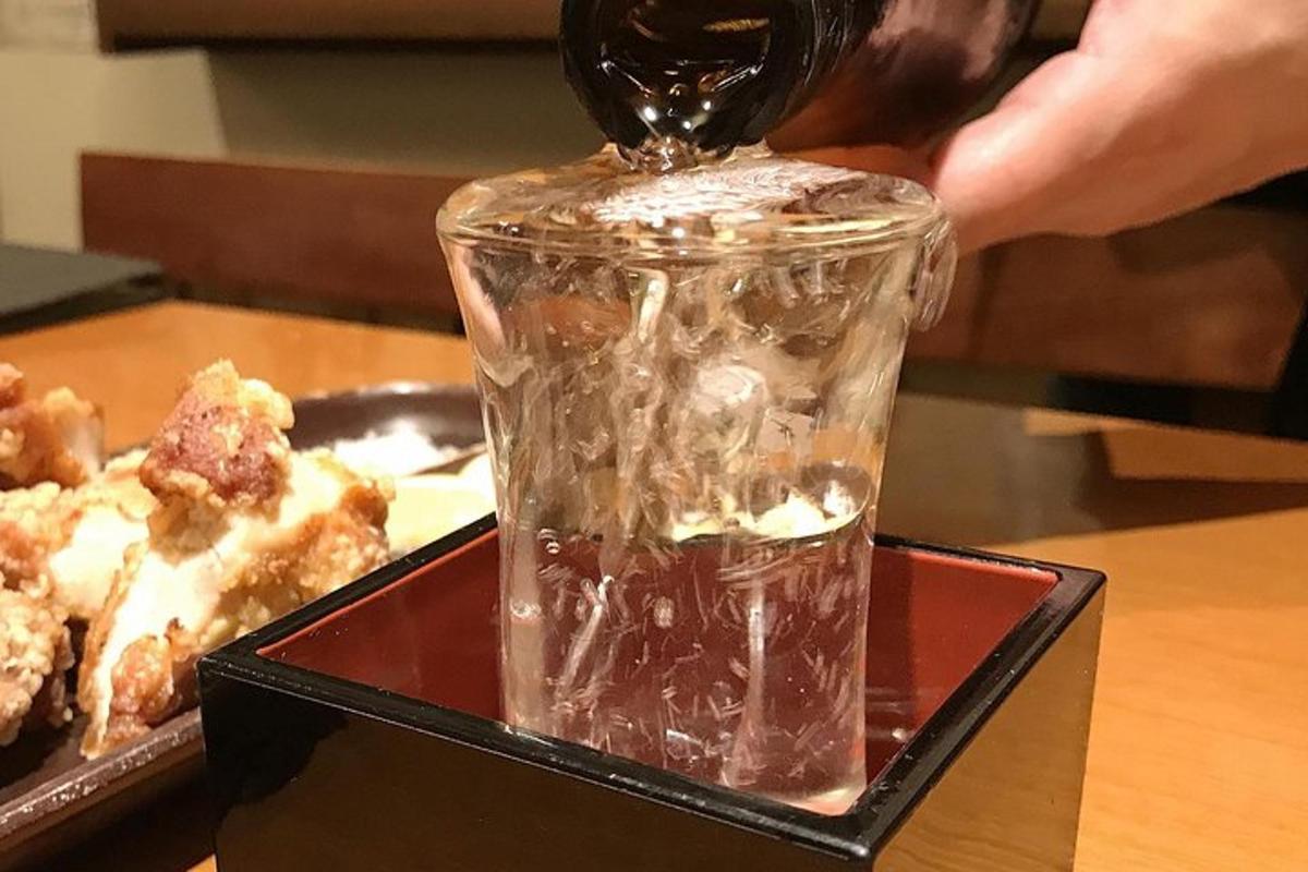 a drink being poured into a glass on a table