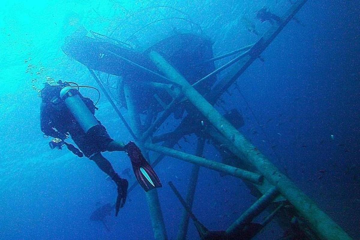 a diver in the water next to a diving device