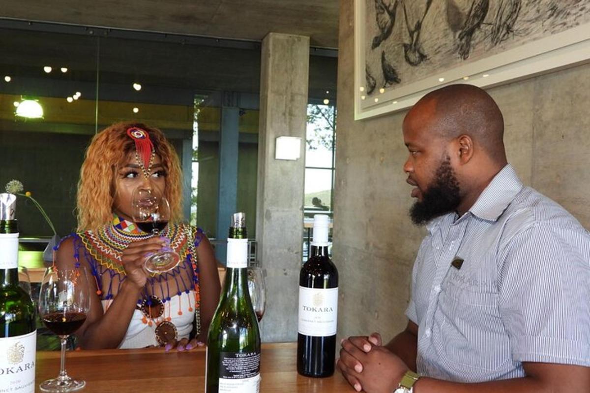 a man and a woman standing at a bar with wine bottles