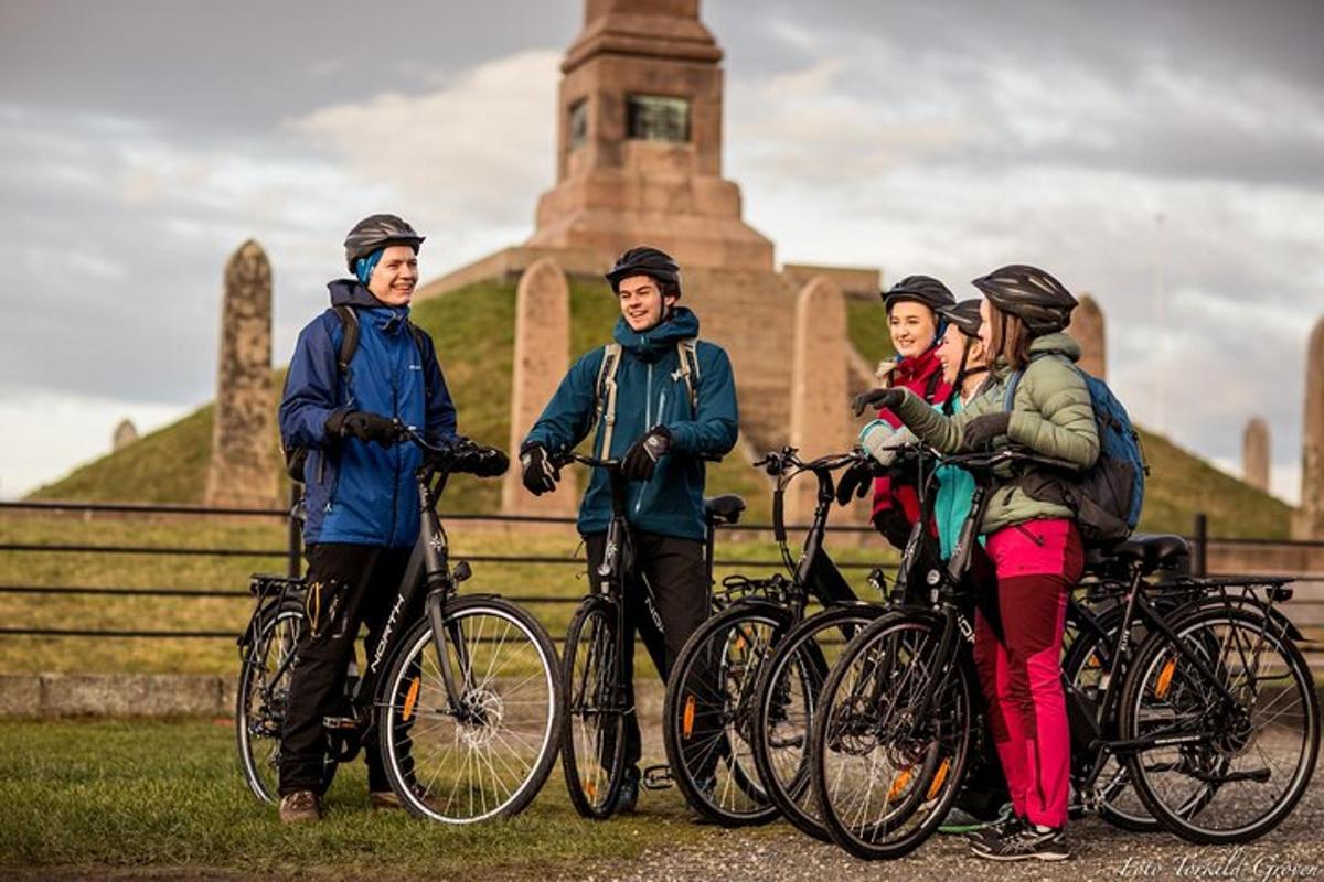 a group of people standing with bikes in front of a building