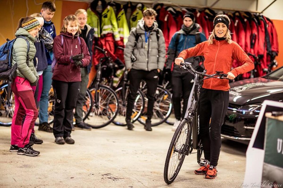a woman riding a bike in front of a group of people