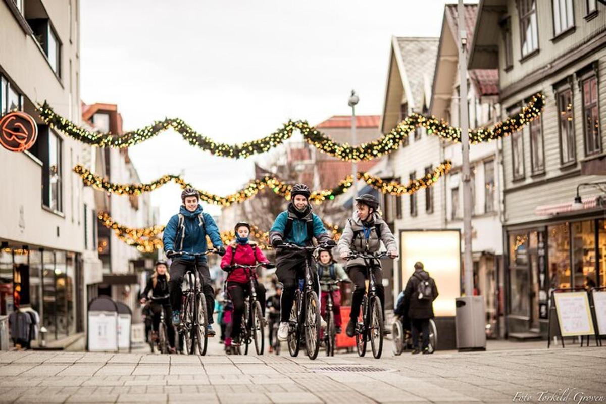 a group of people riding bikes down a street