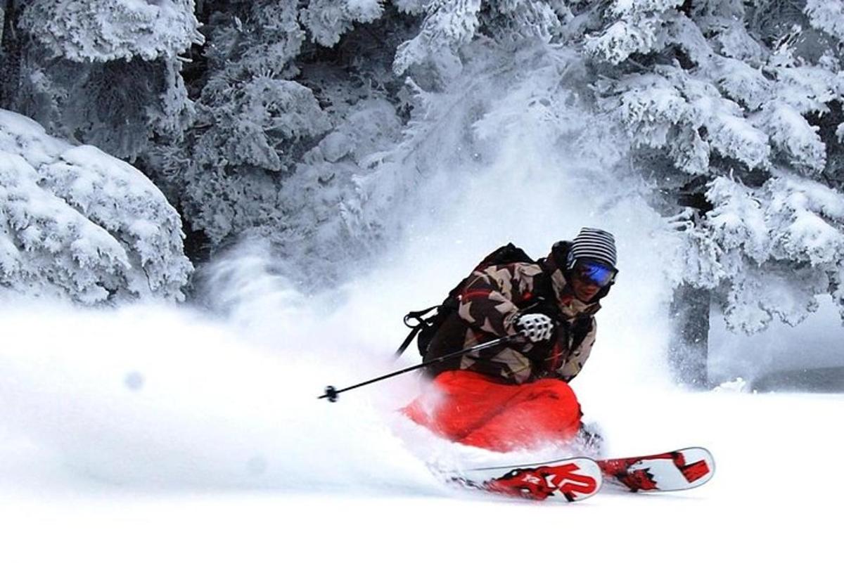 a person is skiing down a snow covered slope