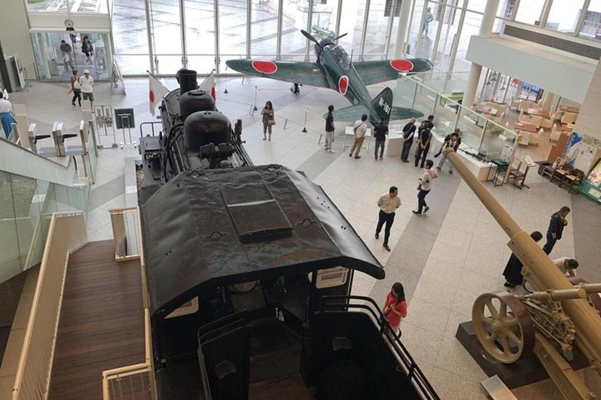 an old airplane on display in a museum with people