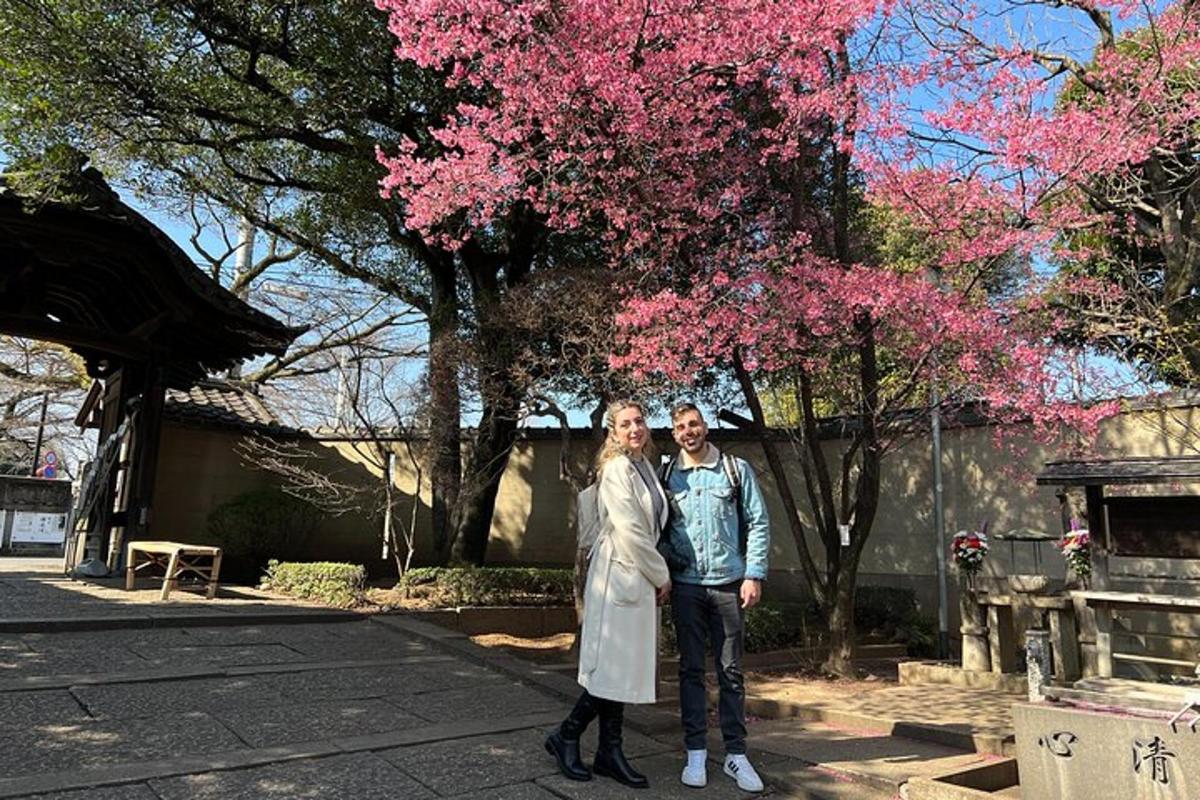 a man and a woman standing in front of a tree