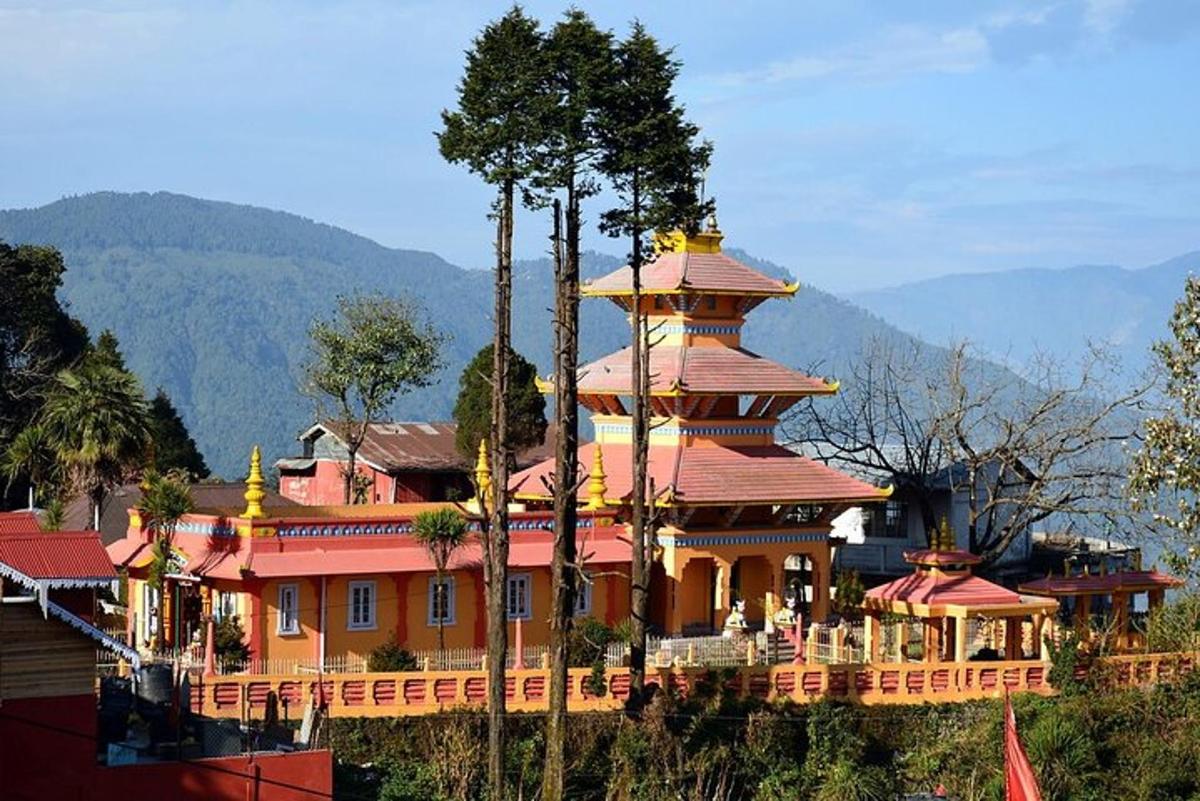 a large orange building with a tower on a hill