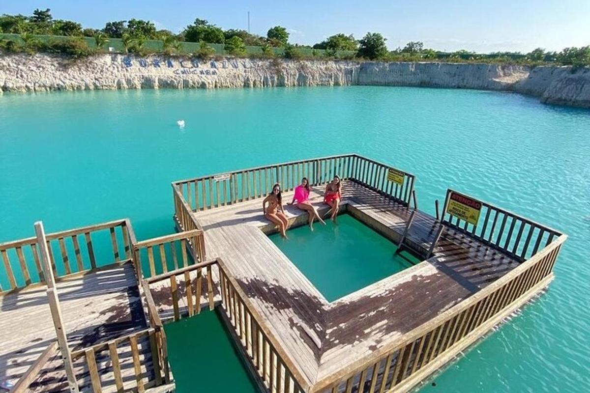 three women sitting on a dock in the water