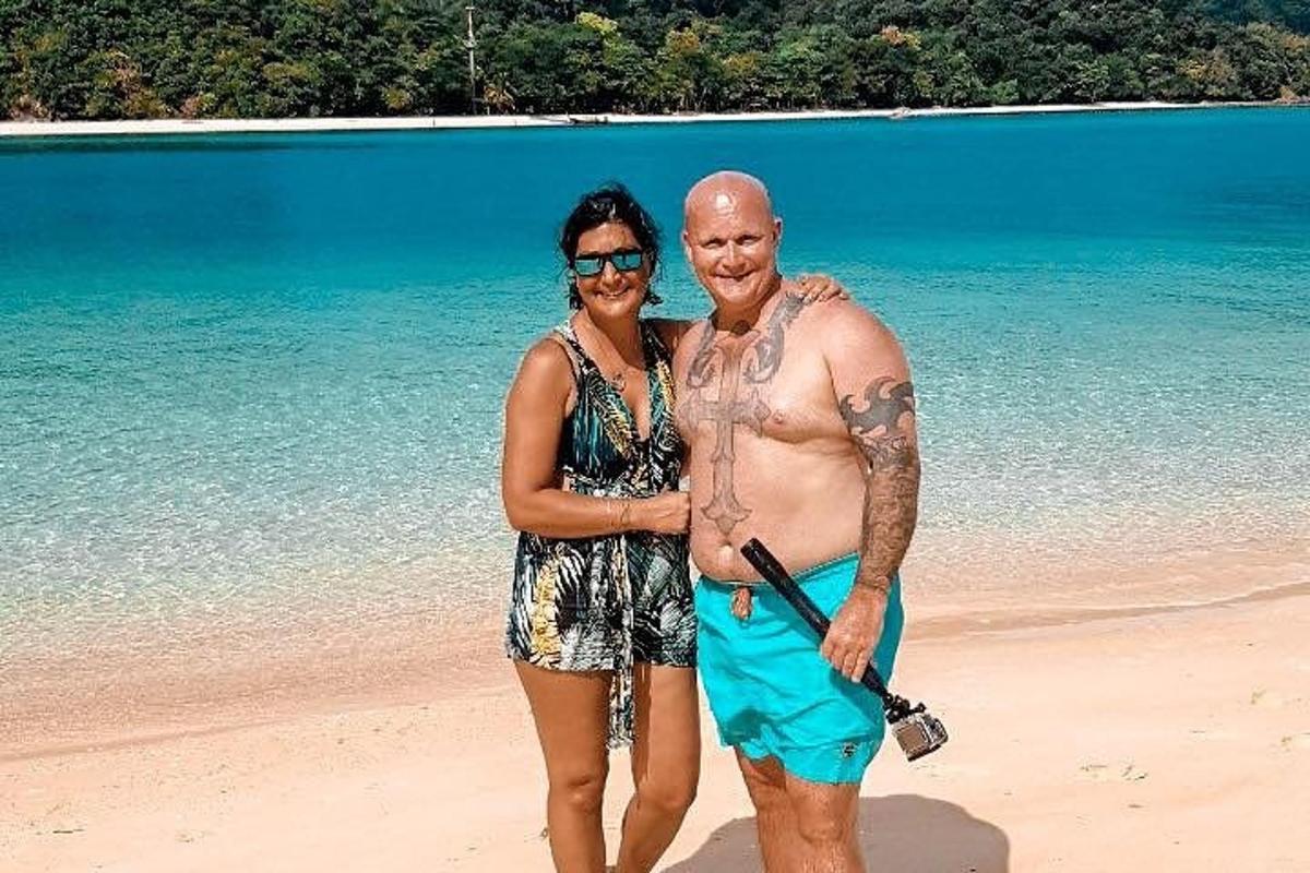 a man and a woman standing on a beach