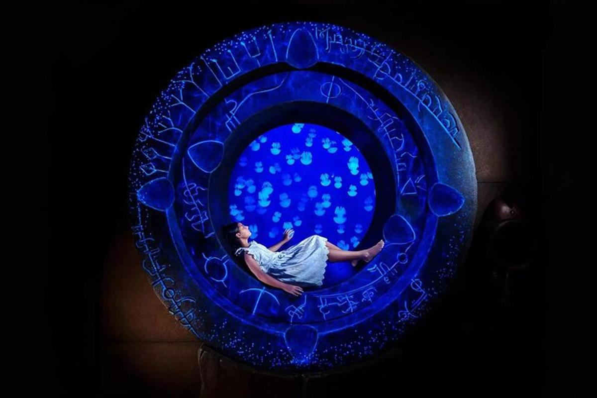 a man is laying in a blue glass bowl