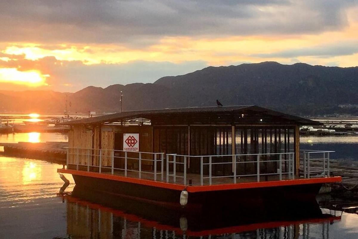 a ferry boat in the water with the sunset