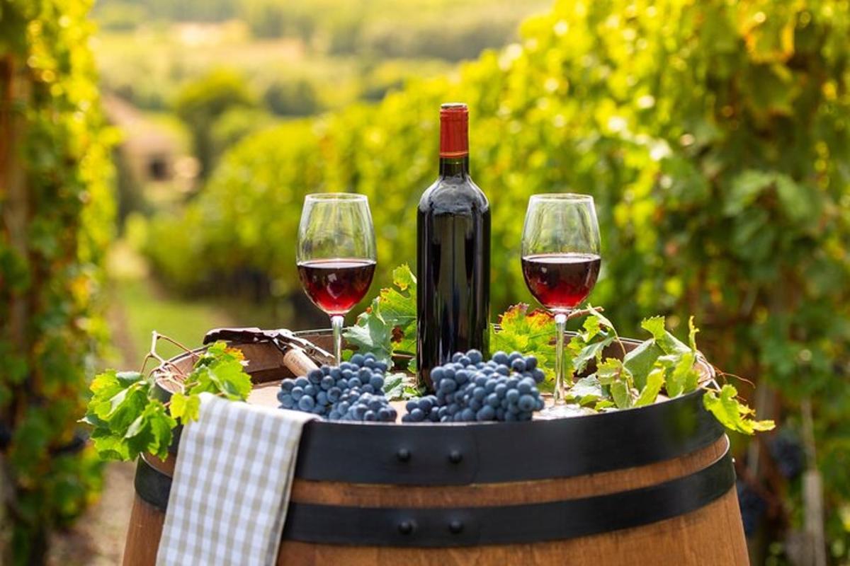 dois copos de vinho e uvas em um barril