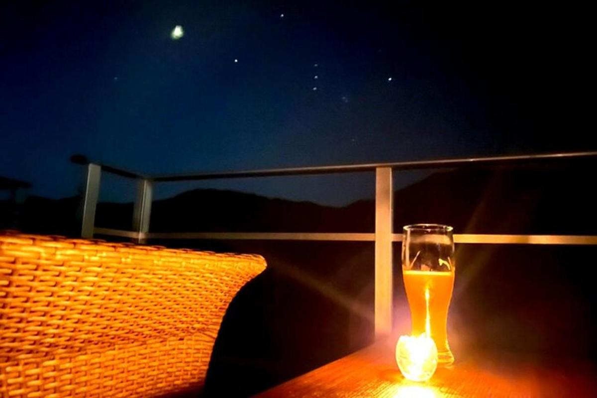 a glass of beer sitting on top of a table