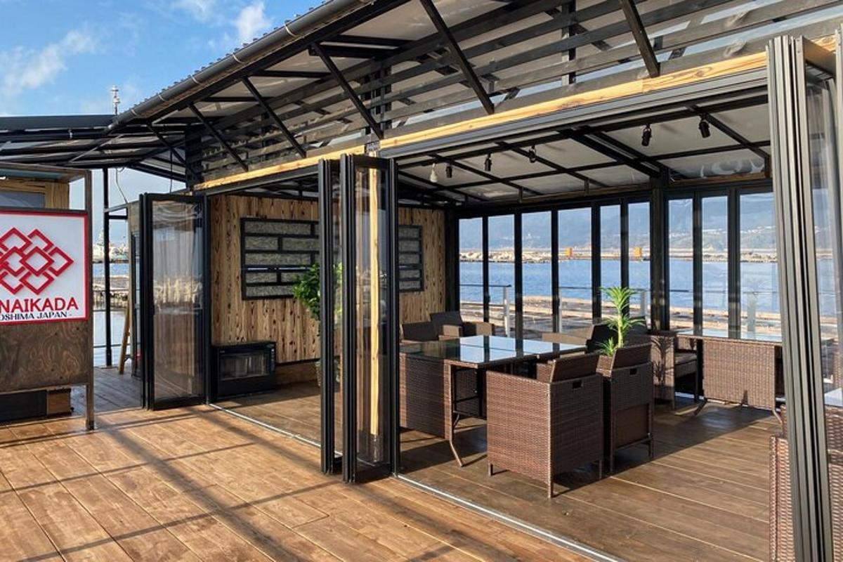 a pavilion with a table and chairs on a deck