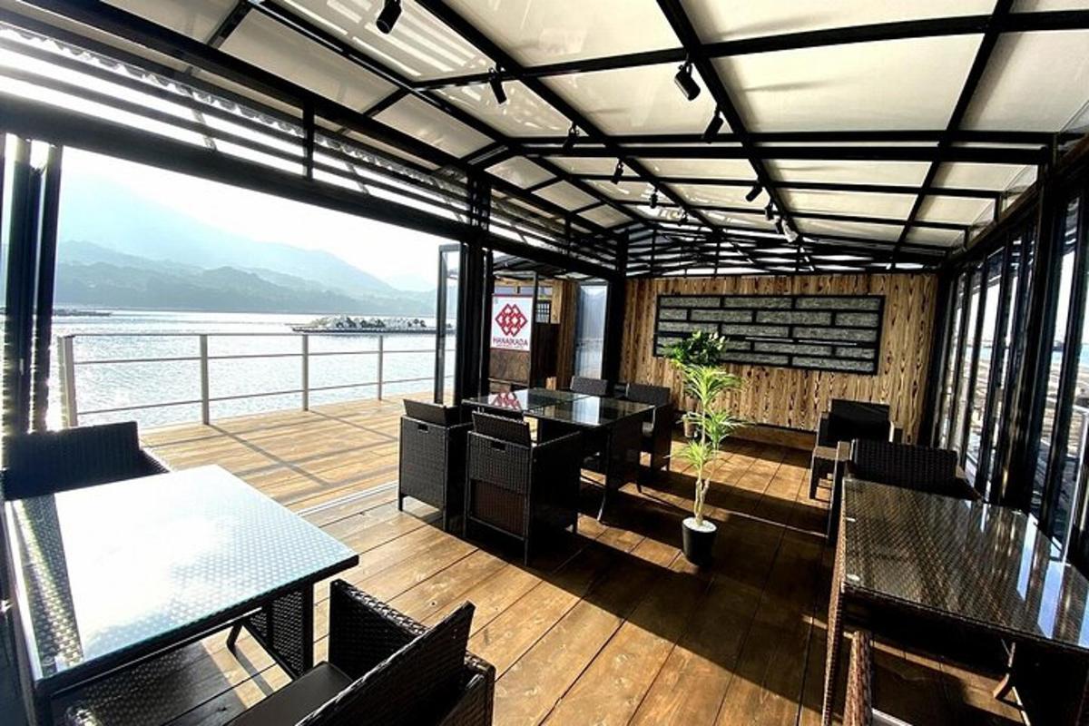 a restaurant with a balcony with a view of the water