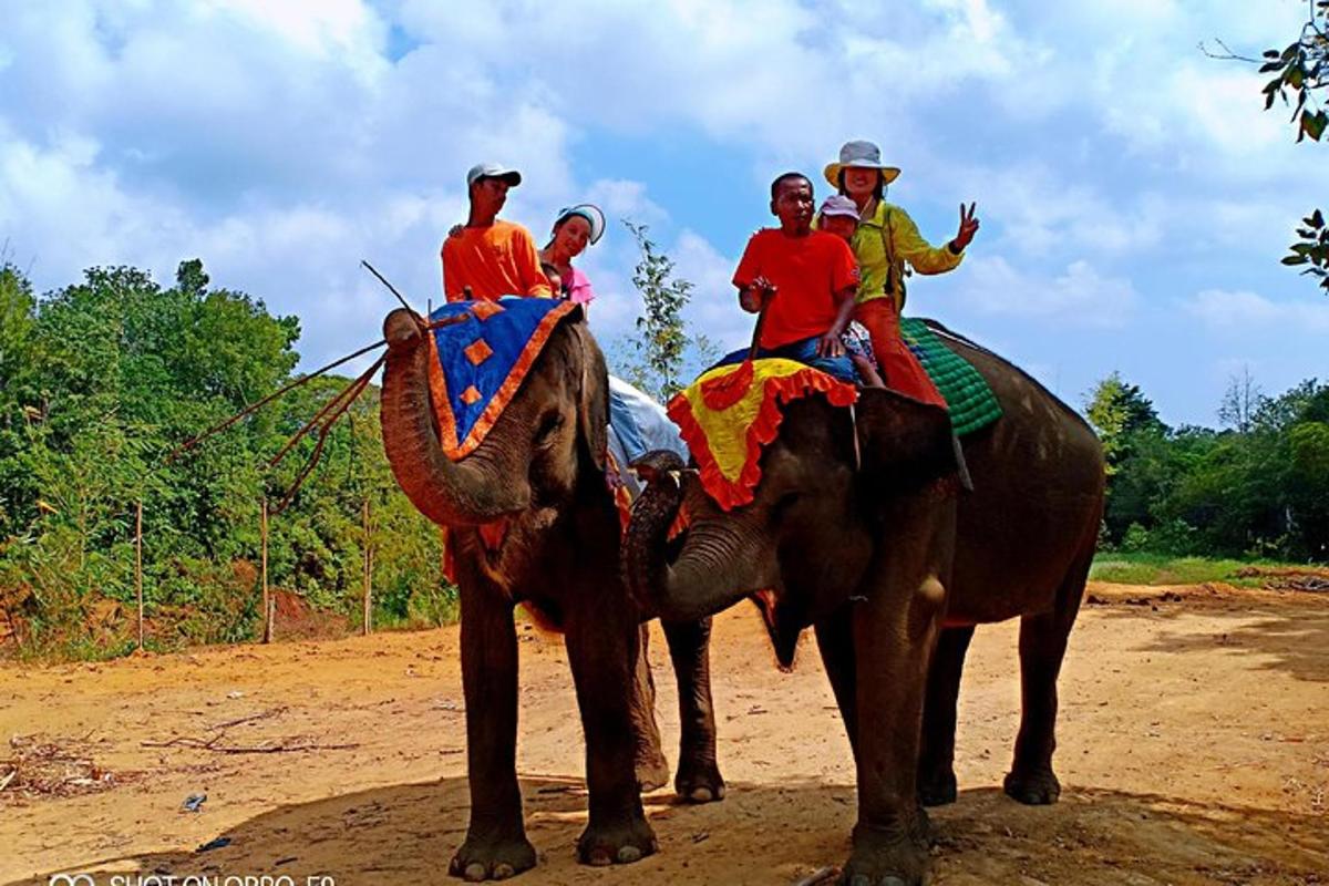a group of people riding on the back of an elephant