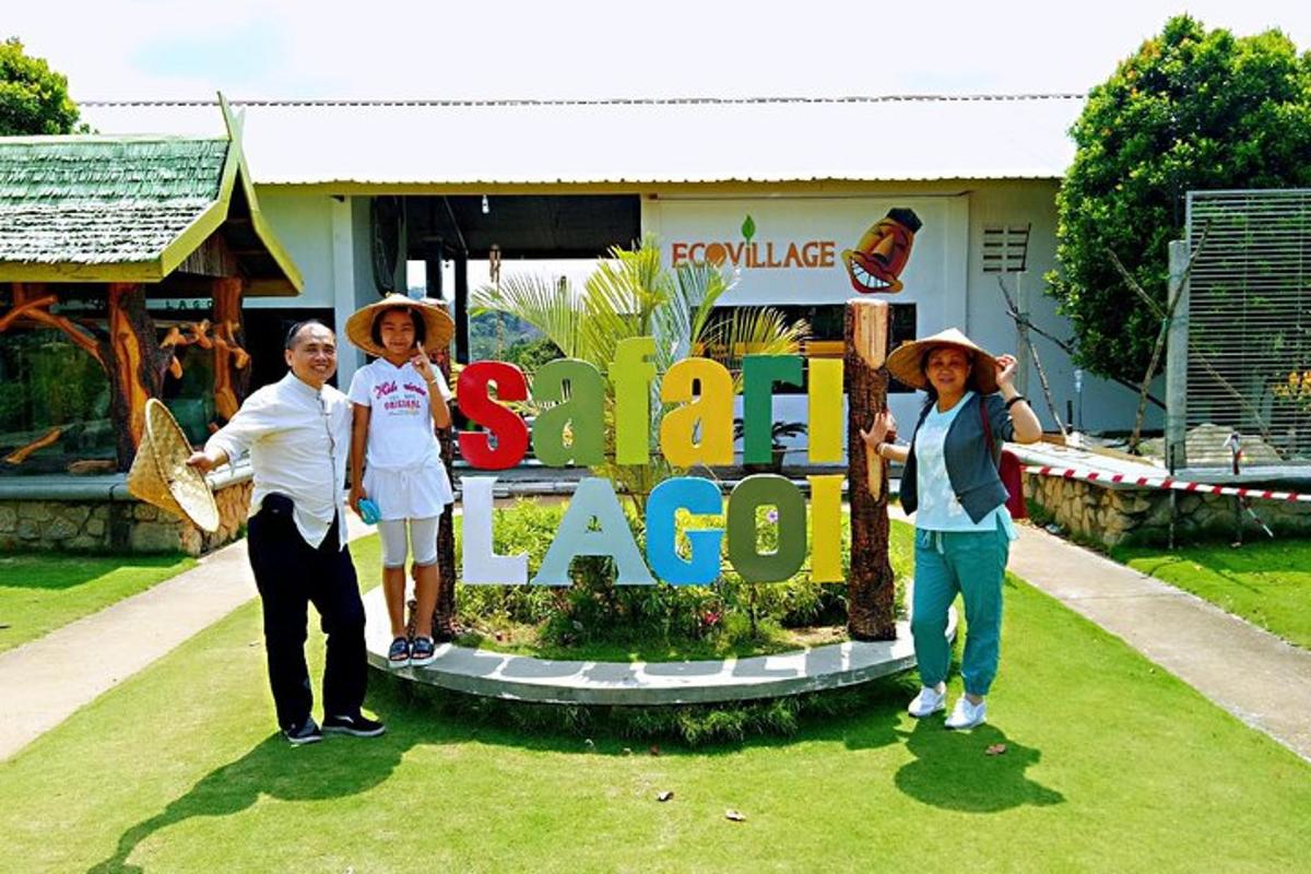 a group of three people standing in front of a sign