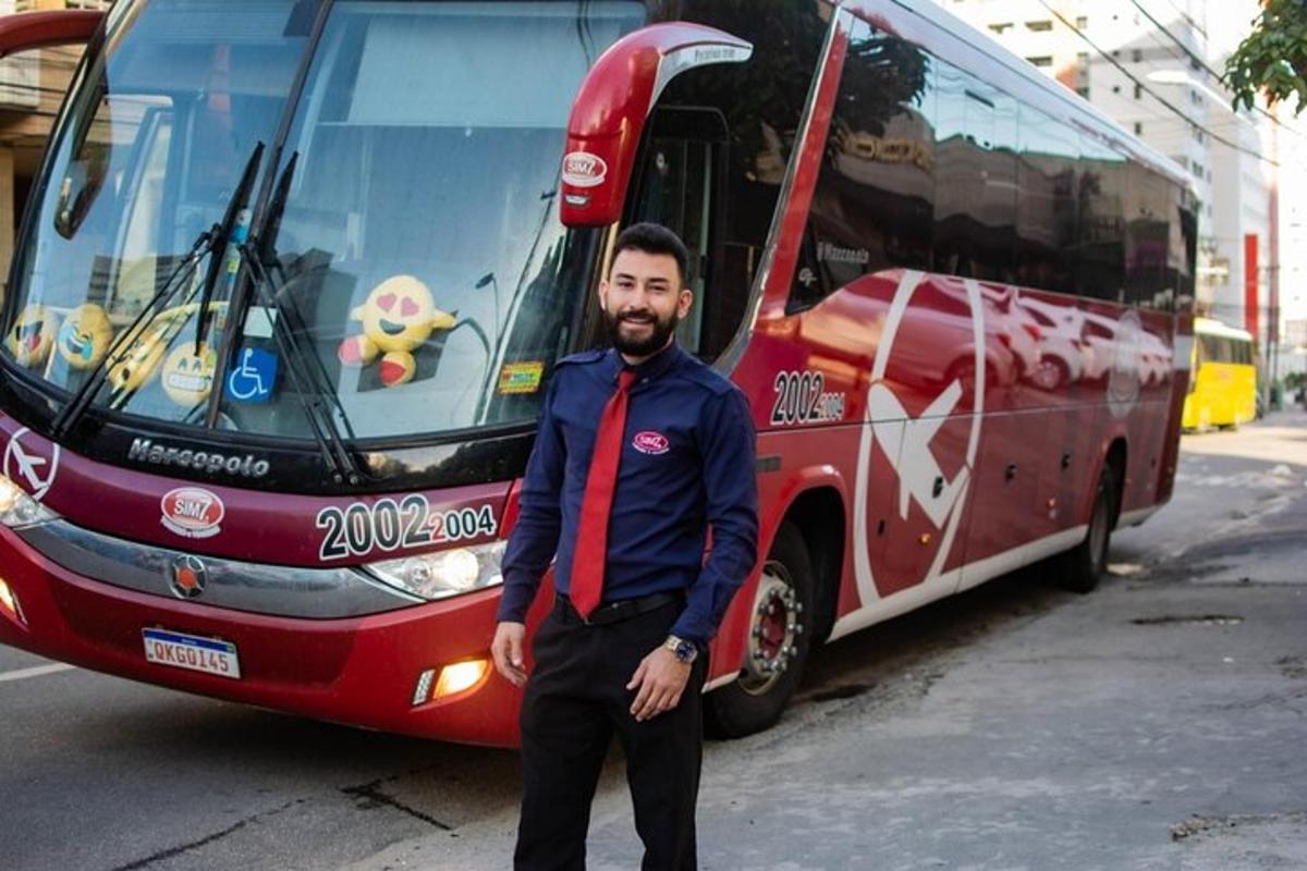 a man is standing in front of a bus