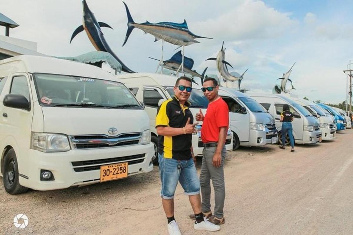 two men standing in front of a row of vans
