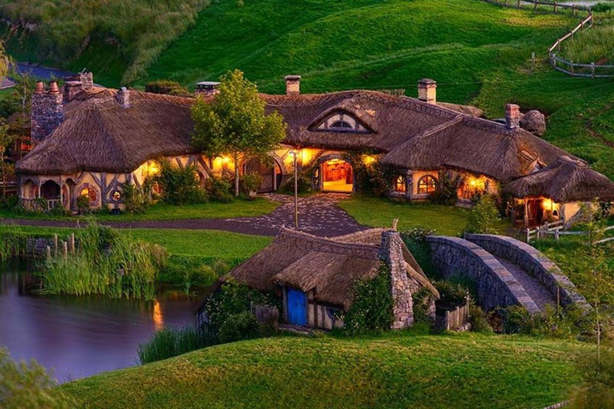 a large house with a pond in front of it
